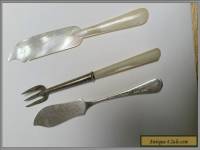 Sterling silver and mother of pearl pickle fork and two butter spreaders